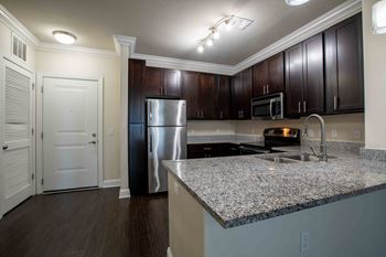 a kitchen with granite counter tops and stainless steel appliances